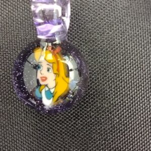 A close up of the face on a purple necklace