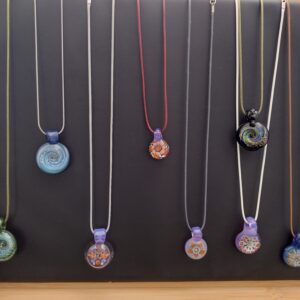 A group of necklaces hanging on the wall.