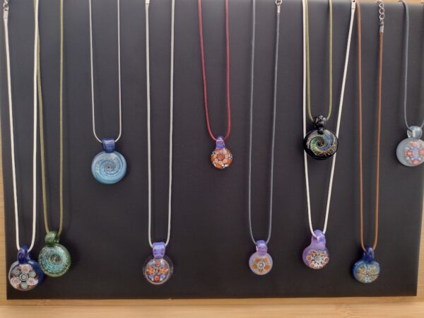 A group of necklaces hanging on the wall.