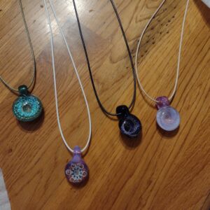 A group of necklaces sitting on top of a wooden table.